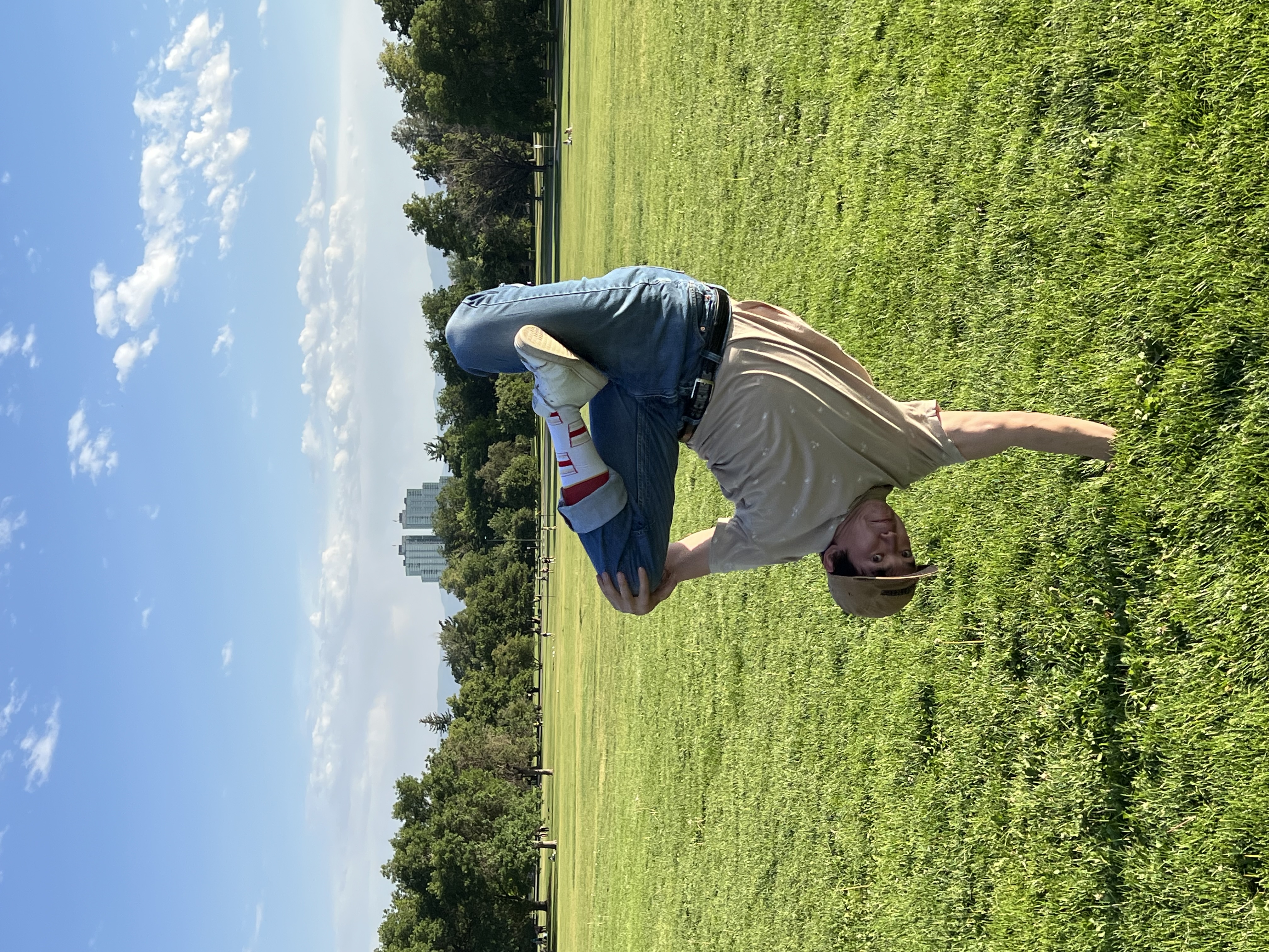 Shadow holding a one-handed freeze in a green park